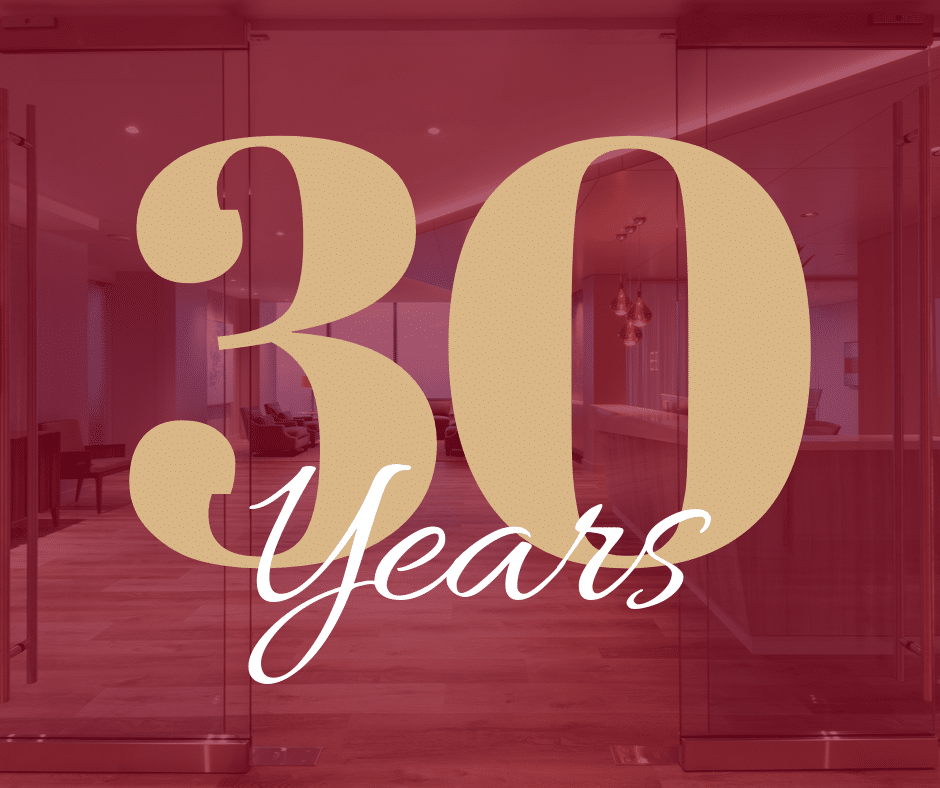 Large beige text on a transparent red overlay reads 30 Years, set against a background of a modern office space with wooden floors and bright lighting.