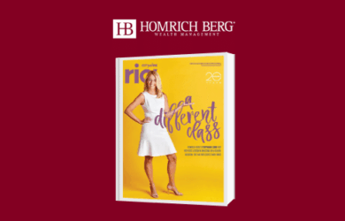 A woman in a white dress stands confidently on the cover of a yellow magazine. The text reads, A Different Class. The logo of Homrich Berg Wealth Management is displayed above the magazine on a red background.