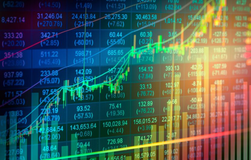 A colorful digital stock market display shows fluctuating graphs, numbers, and bar charts, indicating various financial data trends on a dynamic screen with bright, multicolored lines overlaying the information.