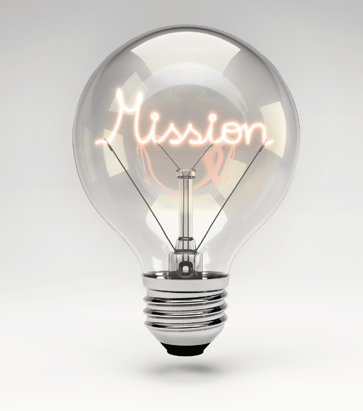A clear light bulb with the word Mission glowing inside as the filament, set against a plain gray background.