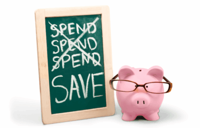 A pink piggy bank wearing glasses sits next to a chalkboard. The board has the word SPEND written and crossed out three times, with the word SAVE below them in large letters.