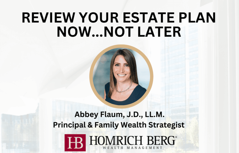 Promotional image with the text Review Your Estate Plan Now...Not Later. Features a portrait of a woman, Abbey Flaum, J.D., L.L.M., with her titles. The Homrich Berg Wealth Management logo is at the bottom. Background shows a modern office interior.
