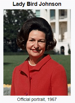 A woman in a red suit with dark hair smiles in front of a blurred background of a building and garden. The text reads Lady Bird Johnson and Official portrait, 1967.