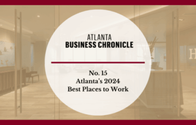A graphic with Atlanta Business Chronicle and No. 15 Atlantas 2024 Best Places to Work in bold text over a blurred office lobby background with a red border.