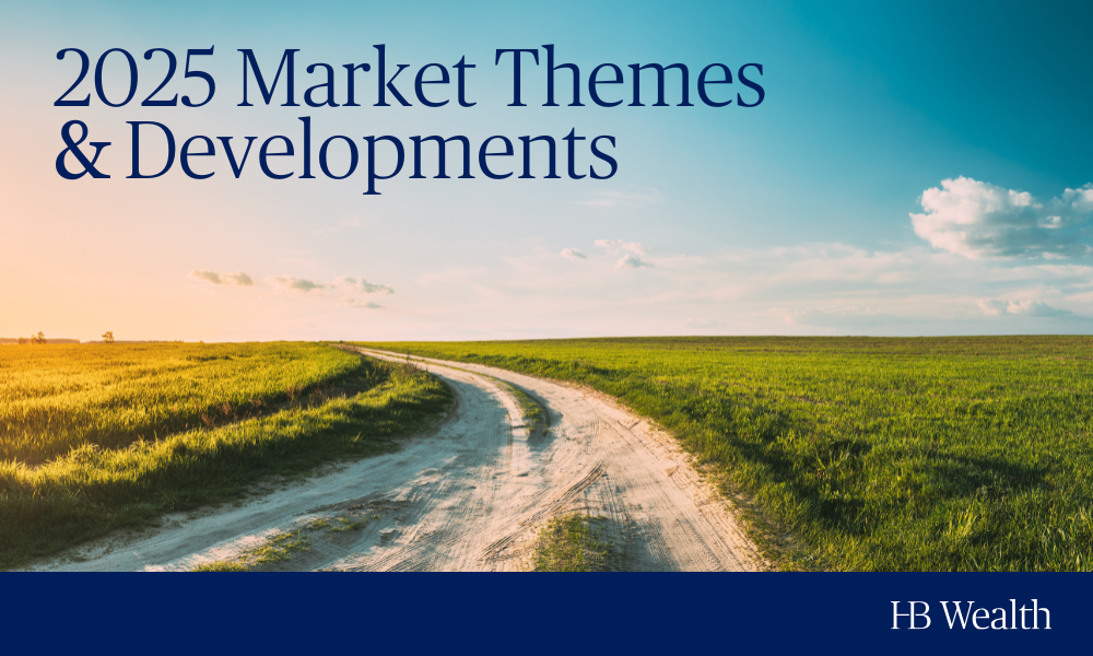 A winding dirt road runs through a green field under a blue sky with clouds. Text reads “2025 Market Themes & Developments.” The image includes the HB Wealth logo in the bottom right corner.