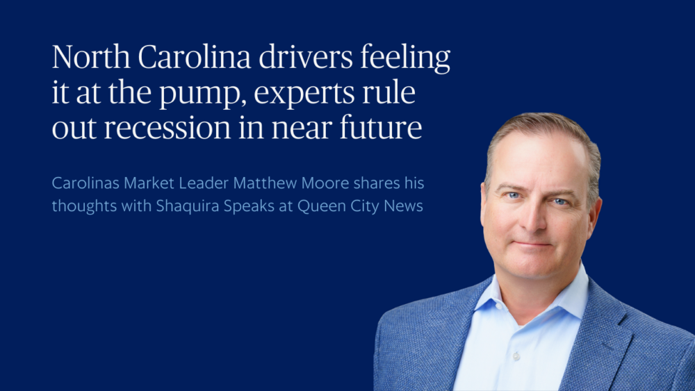A man in a blue jacket and light blue shirt stands in front of a blue background with text about North Carolina drivers, recession concerns, and an interview on Queen City News.