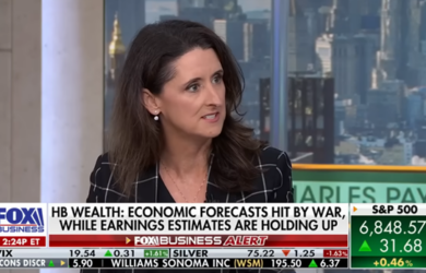 A woman with long brown hair in a plaid blazer speaks in a TV studio. A news banner reads: HB Wealth: Economic forecasts hit by war, while earnings estimates are holding up. Stock tickers scroll along the bottom.